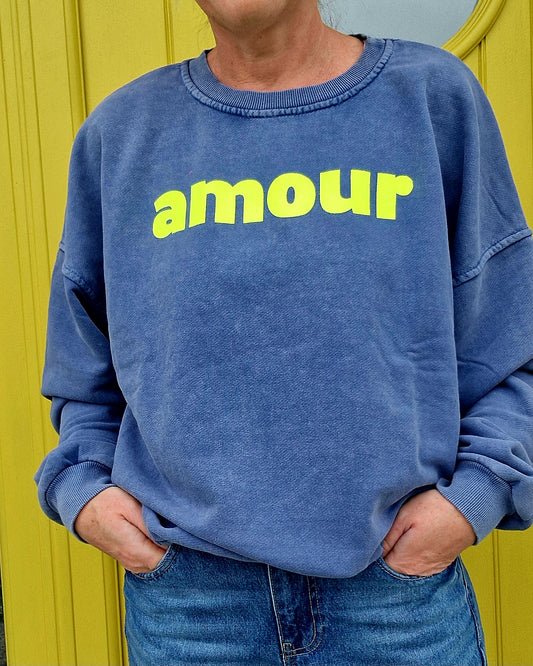 Ladies Blue Sweatshirt with Neon Yellow Amour Font.