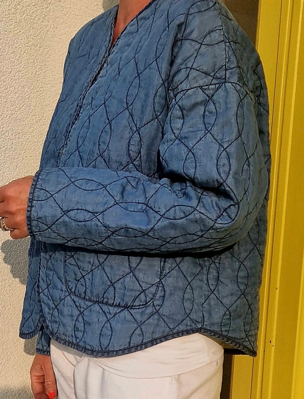 Collarless, Quilted Denim jacket. Open with pockets.