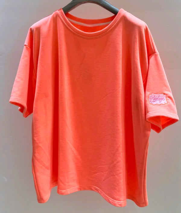 Neon Coral Tee/ Light Sweater. Short sleeve. Vintage logo on sleeve